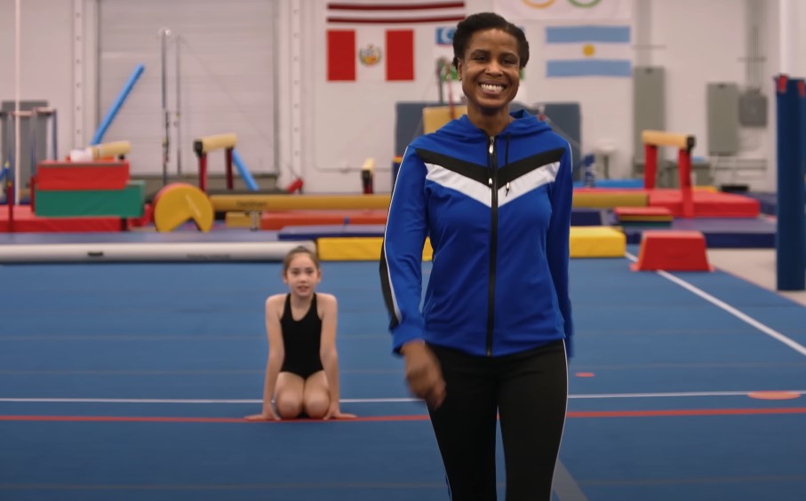 Foster parent practicing gymnastics with foster child